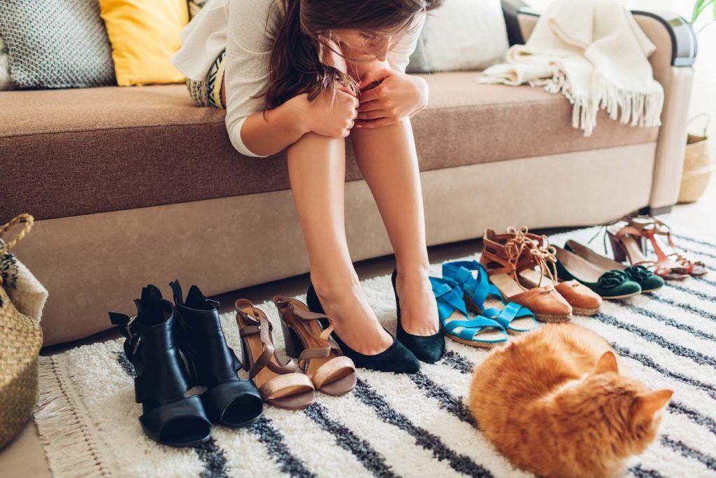 Woman trying on her shoes from her collection