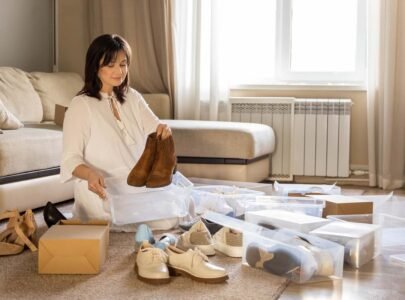 Woman arrangement shoes into plastic container